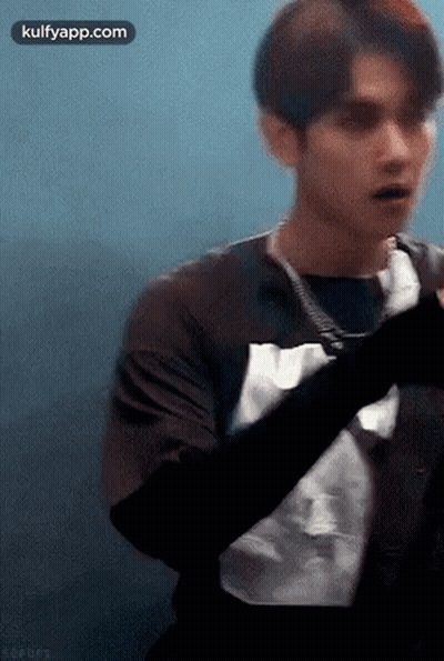 Young Man In Black Shirt Looking At Camera GIF