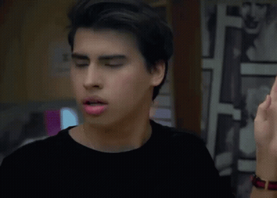Young Man In Black Shirt Looking In Mirror GIF