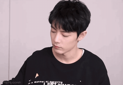 Young Man In Black Shirt With Chinese Writing Making A Face GIF