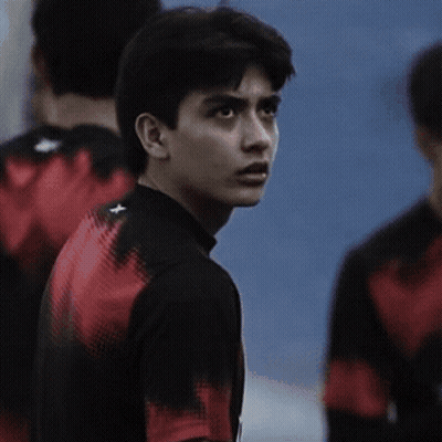 Young Man In Black Shirt With Red Stripe Sleeves GIF