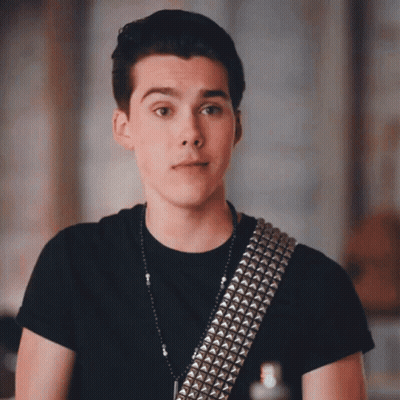 Young Man In Black Shirt With Studded Guitar Strap GIF