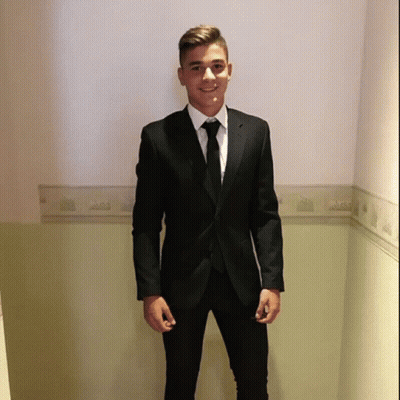 Young Man In Black Suit And Tie Hallway GIF