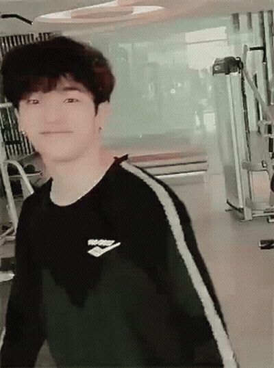 Young Man In Black Sweater Smiling At Gym GIF