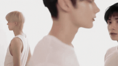 Young Man In Black Sweater With Chinese Characters GIF