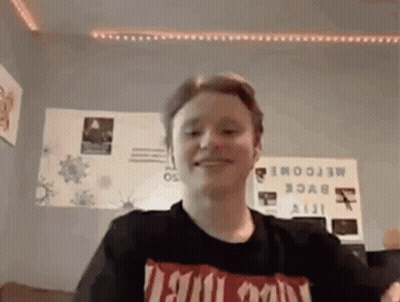 Young Man In Black T-Shirt Smiling GIF