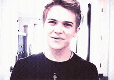 Young Man In Black T-Shirt Smiling With Cross Necklace GIF