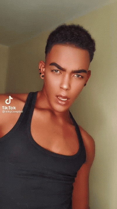 Young Man In Black Tank Top And Earrings GIF