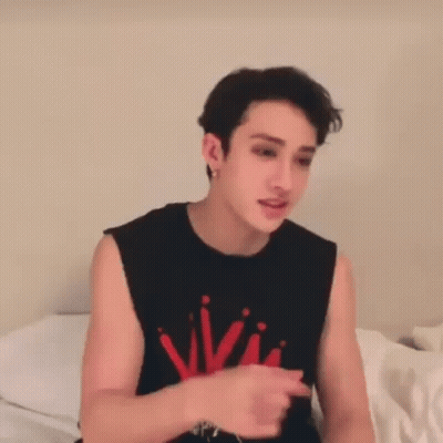 Young Man In Black Tank Top Red Writing GIF