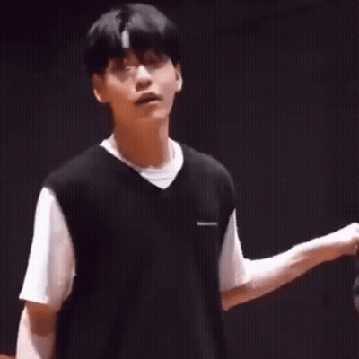 Young Man In Black Vest And White T-Shirt Hands Folded GIF