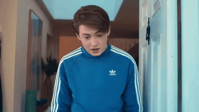 Young Man In Blue Adidas Sweater Standing In Doorway GIF