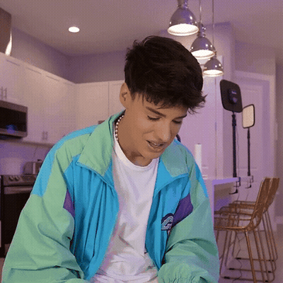 Young Man In Blue And Green Jacket With Letter G GIF