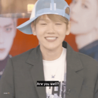 Young Man In Blue Hat And Black Jacket Saying Are You Well GIF