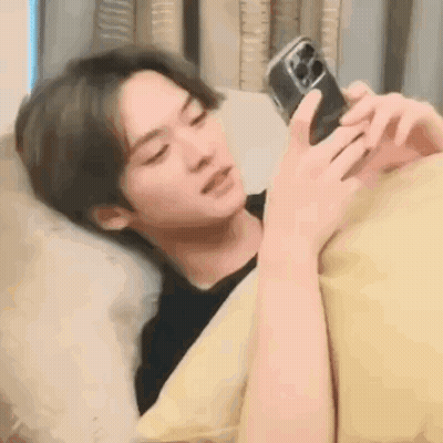 Young Man In Blue Hoodie Laying Down GIF
