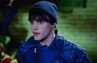 Young Man In Blue Jacket And Beanie In Dark GIF