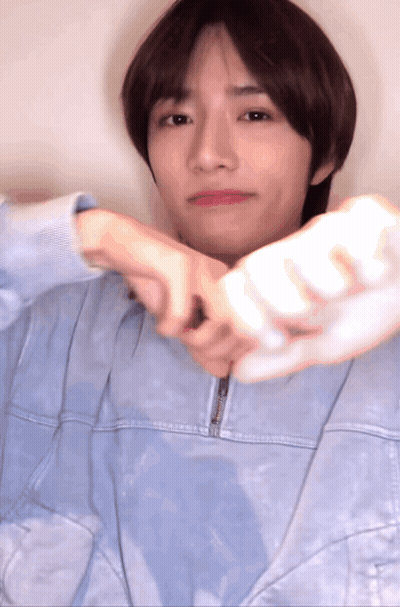 Young Man In Blue Jacket Holding White Object GIF