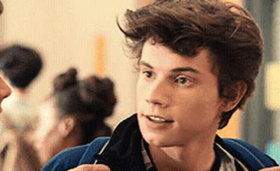 Young Man In Blue Jacket Talking To Woman GIF