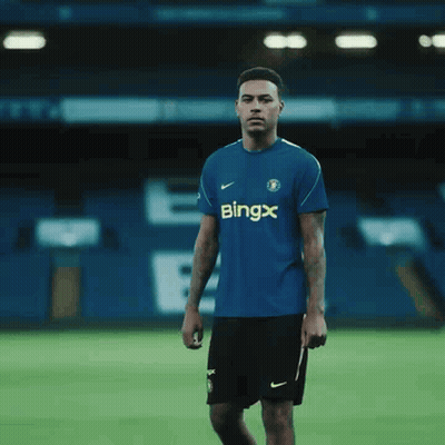 Young Man In Blue Shirt Adjusting Tie GIF