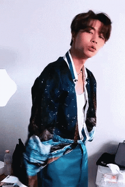 Young Man in Blue Shirt and Blue Pants Standing in Room