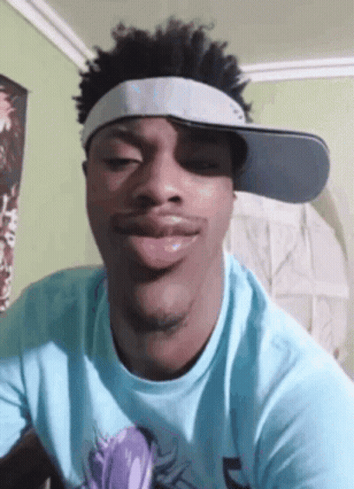 Young Man In Blue Shirt And Hat Making Funny Face GIF