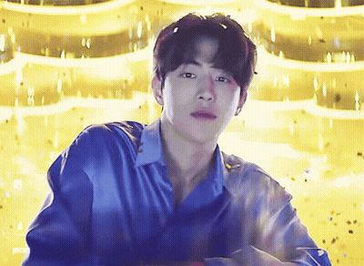 Young Man In Blue Shirt Gold Background GIF