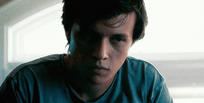 Young Man In Blue Shirt Looking At Camera GIF
