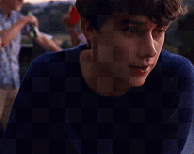 Young Man In Blue Shirt Looking Left GIF