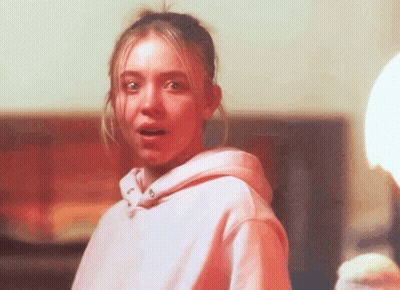 Young Man In Blue Shirt Looking Out Window GIF
