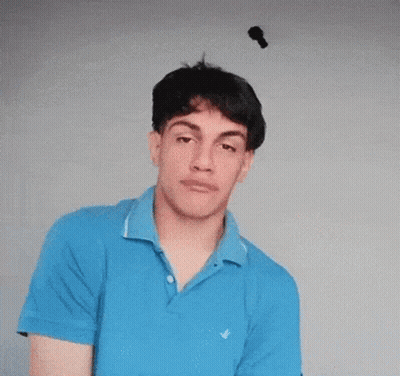 Young Man In Blue Shirt Making Funny Face GIF