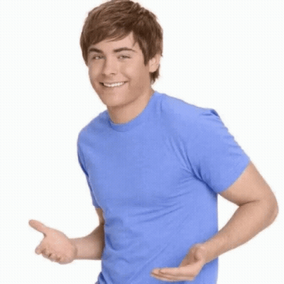 Young Man In Blue Shirt Smiling And Pointing GIF