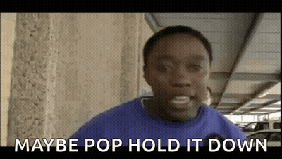 Young Man In Blue Shirt Standing In Parking Garage GIF
