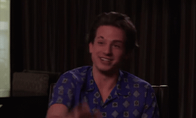 Young Man In Blue Shirt Waving GIF