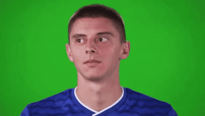 Young Man In Blue Soccer Jersey Looking Up On Green Screen GIF