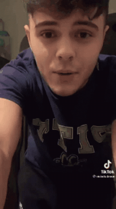 Young Man In Blue T-Shirt Standing GIF