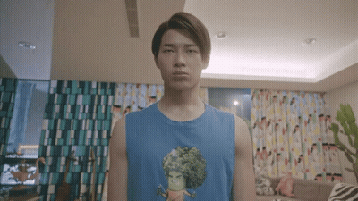 Young Man In Blue Tank Top With Cartoon Character GIF