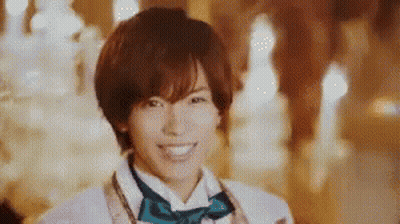 Young Man In Bow Tie And White Jacket Smiling GIF