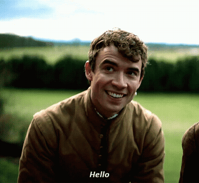 Young Man In Brown Jacket Saying Hello GIF
