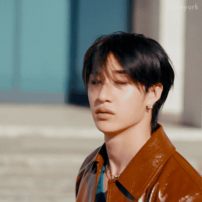 Young Man In Brown Leather Jacket With Earrings GIF