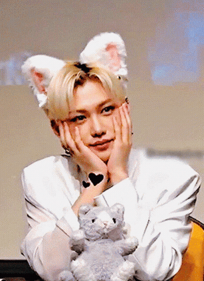 Young Man In Bunny Ears Holding Stuffed Animal GIF