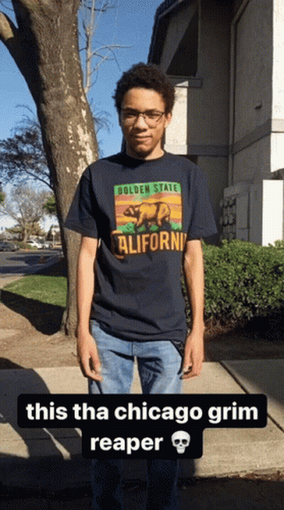 Young Man In California T-Shirt On Sidewalk GIF