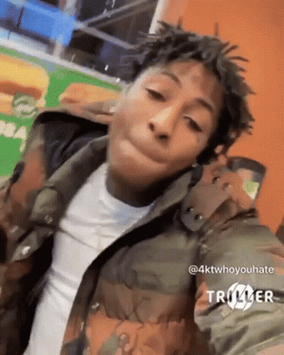 Young Man In Camouflage Jacket Taking Selfie GIF
