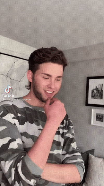Young Man In Camouflage Sweater With TikTok Sticker GIF