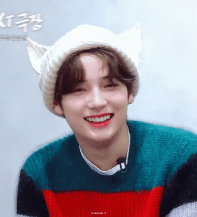 Young Man In Cat Ear Hat And Striped Sweater Smiling GIF