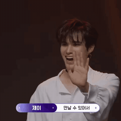 Young Man in Choker and White Shirt With Korean Writing