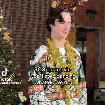 Young Man In Christmas Sweater With Reindeer Antlers GIF