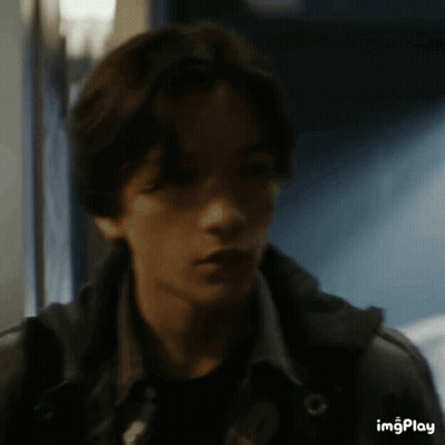 Young Man In Dark Hallway Close Up GIF