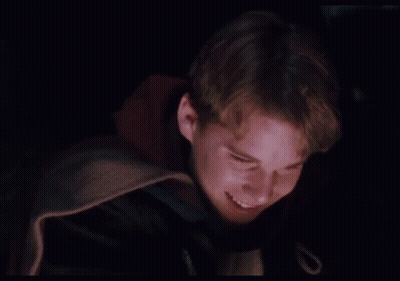 Young Man In Dark Room With Purple Light GIF