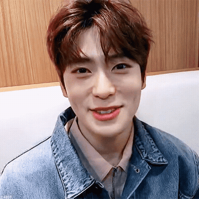 Young Man In Denim Jacket And Pink Shirt Smiling GIF