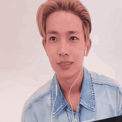 Young Man in Denim Shirt With Earbuds