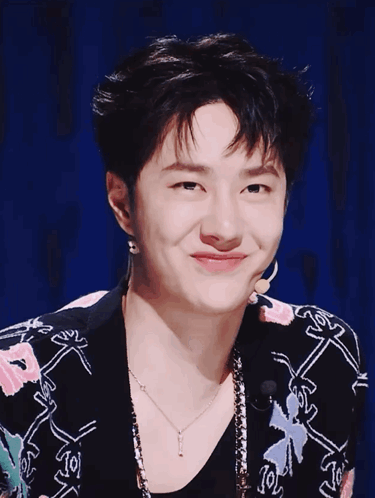 Young Man In Floral Jacket And J Necklace GIF