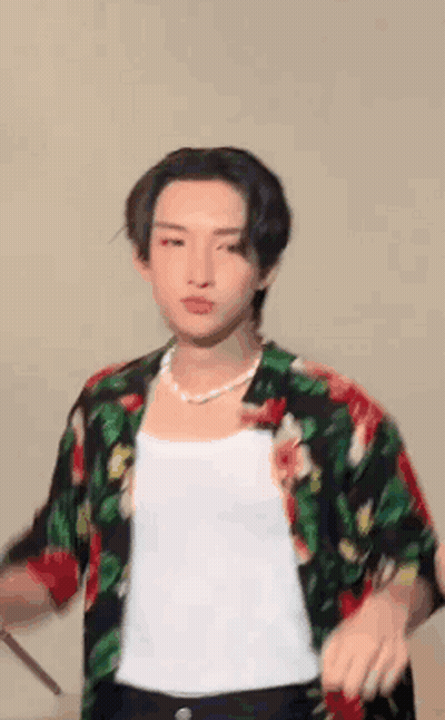 Young Man In Floral Shirt Holding Drum Stick GIF